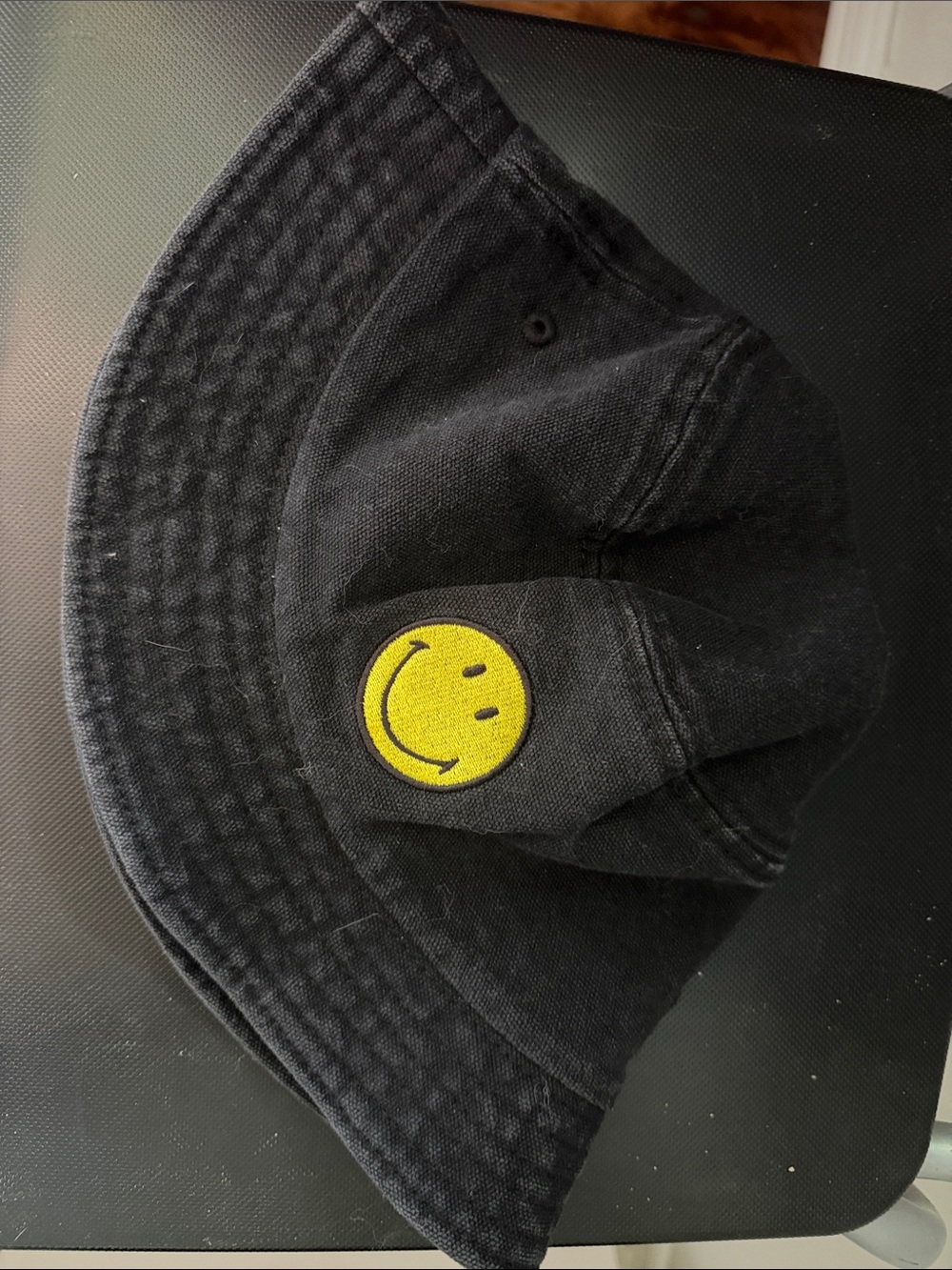 Black Bucket Hat with Yellow Smiley Patch